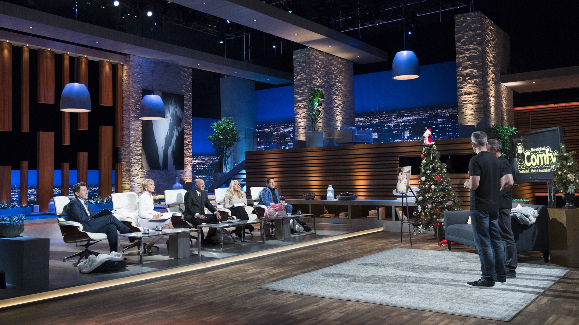 The Comfy founders present the wearable blanket to the Sharks on the Shark Tank set.